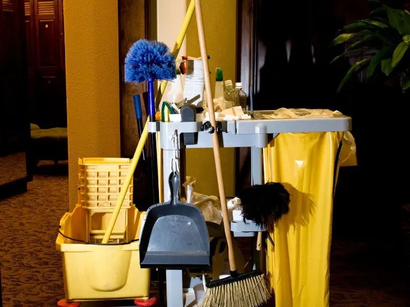 Professional cleaning equipment neatly arranged in a janitor’s cart