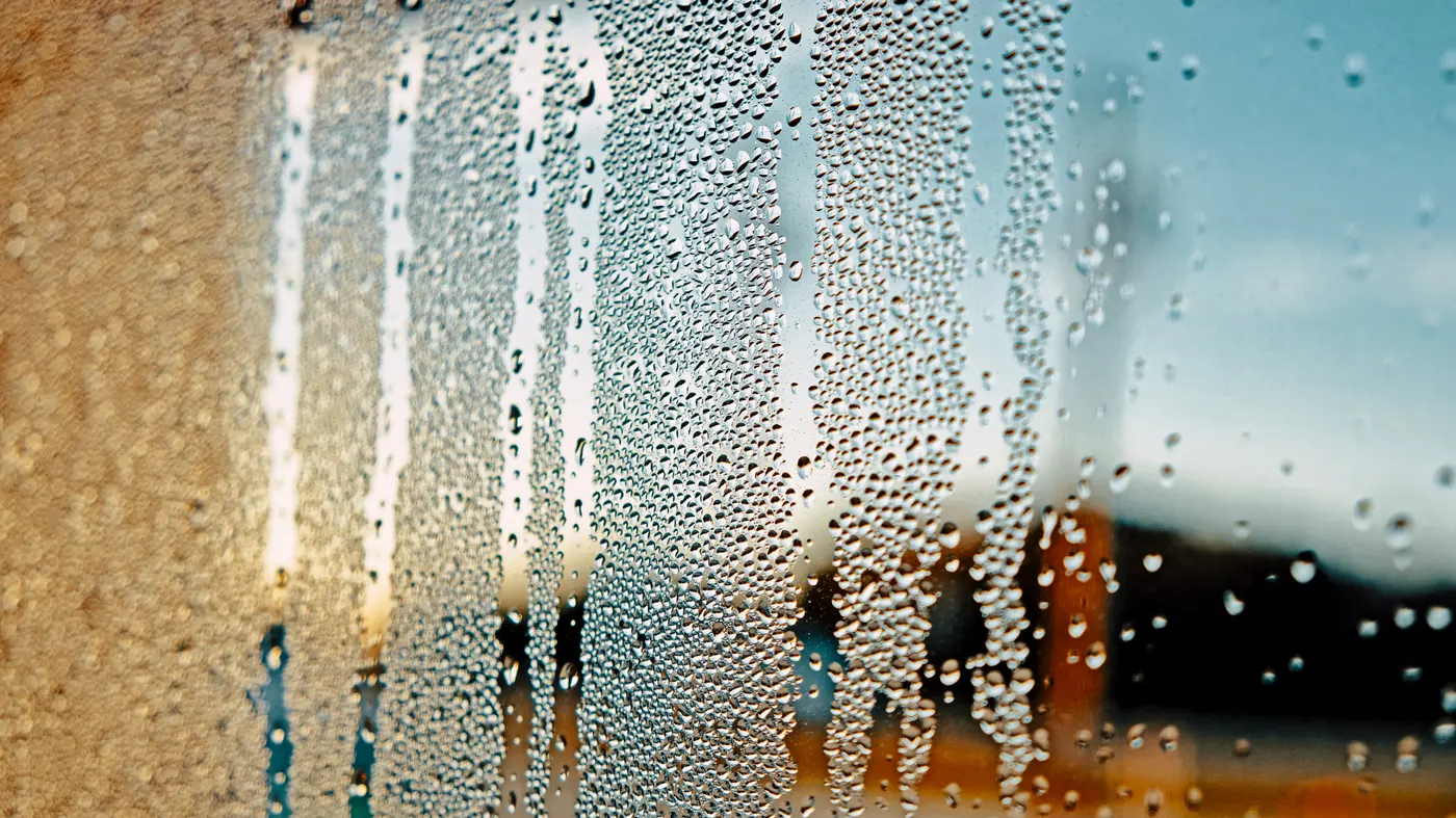 Close-up of office windows with raindrops, showcasing how Dublin's rainy weather impacts window cleanliness.