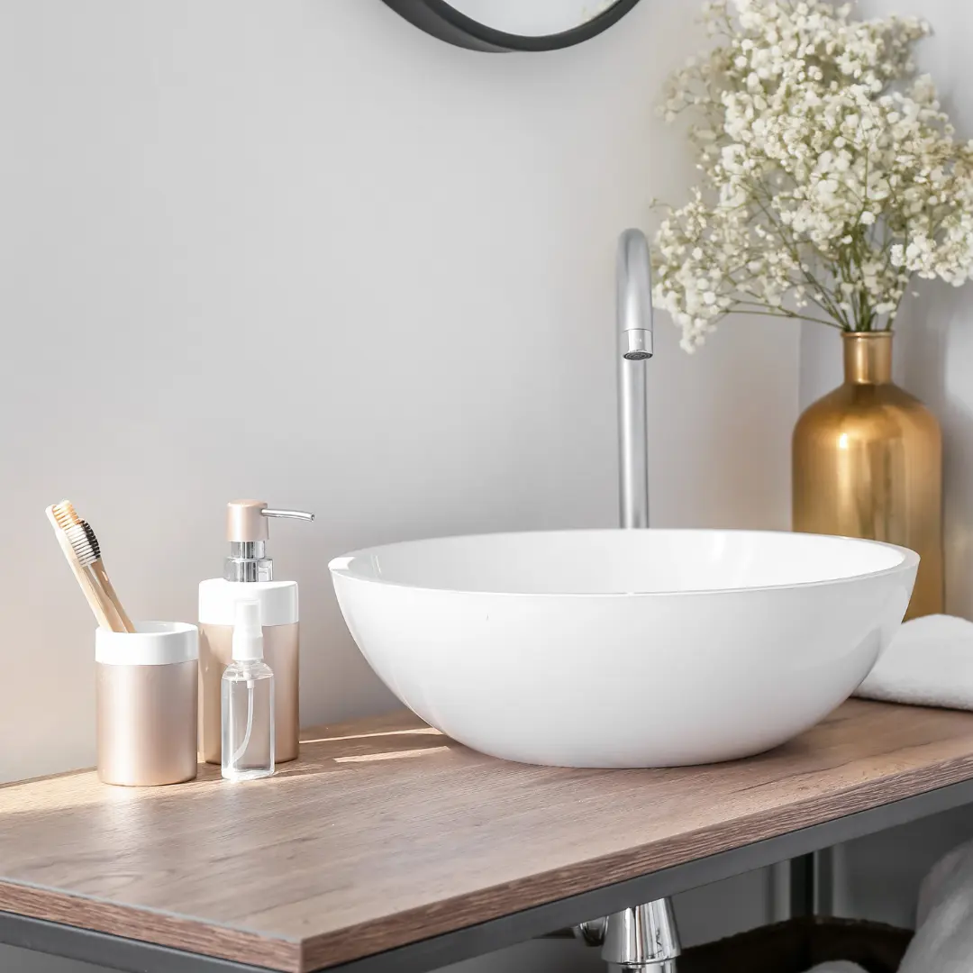 A sparkling clean sink in a bathroom with natural cleaning products.